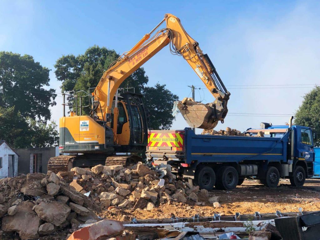 Digger on a pile of rubble
