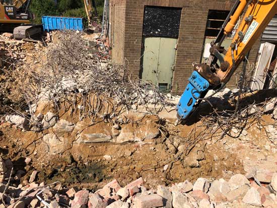 Machine breaking up bricks into rubble