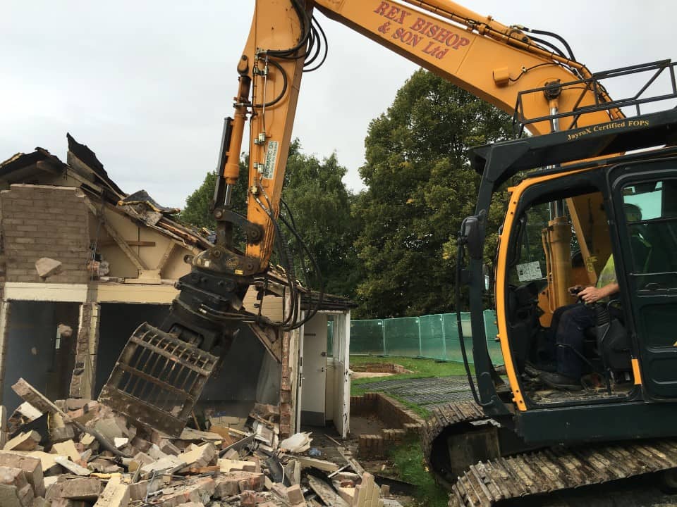 Digger grabbing a pile of bricks