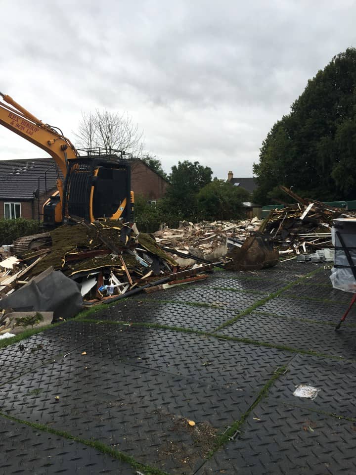 Digger next to a pile of rubble