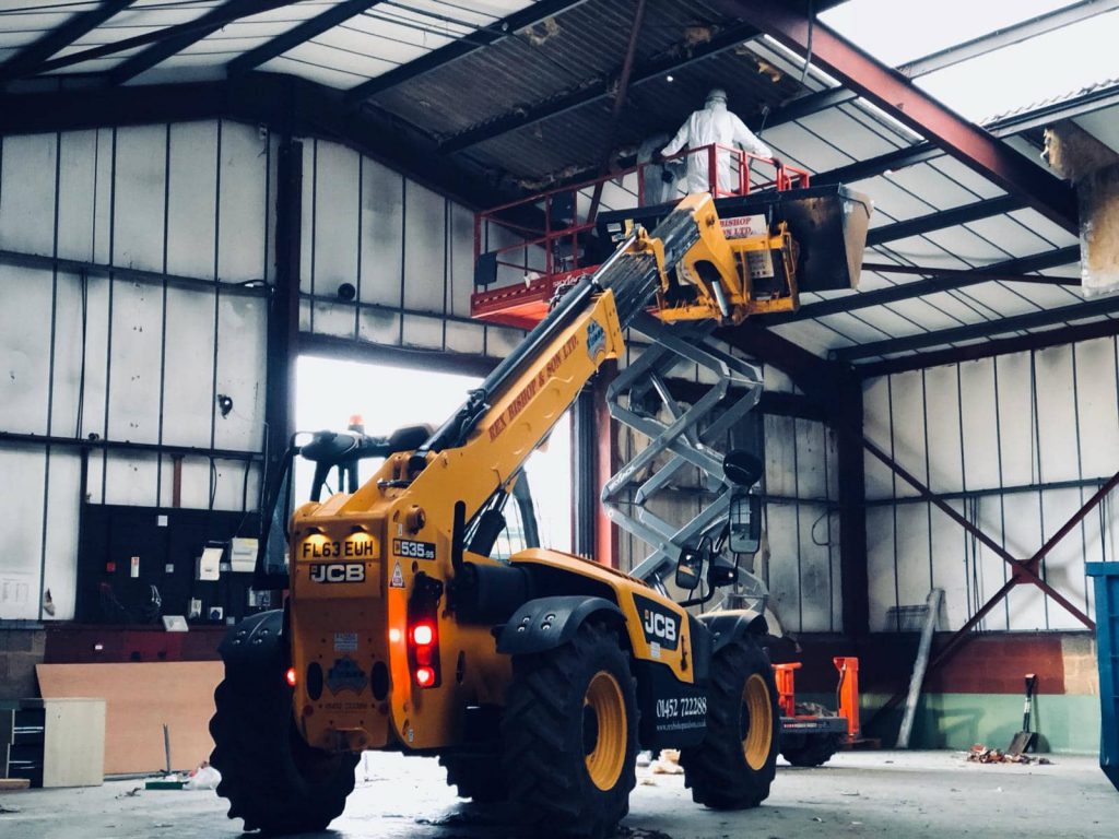 Worker getting lifted by machiner