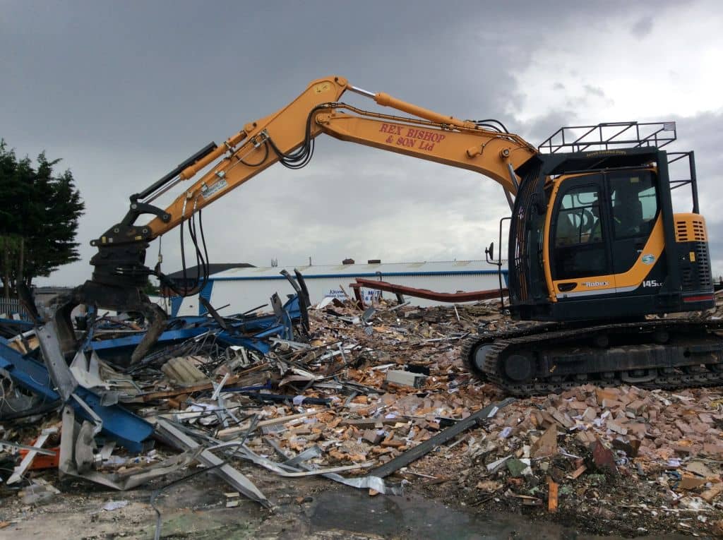 Digger on a pile of rubble