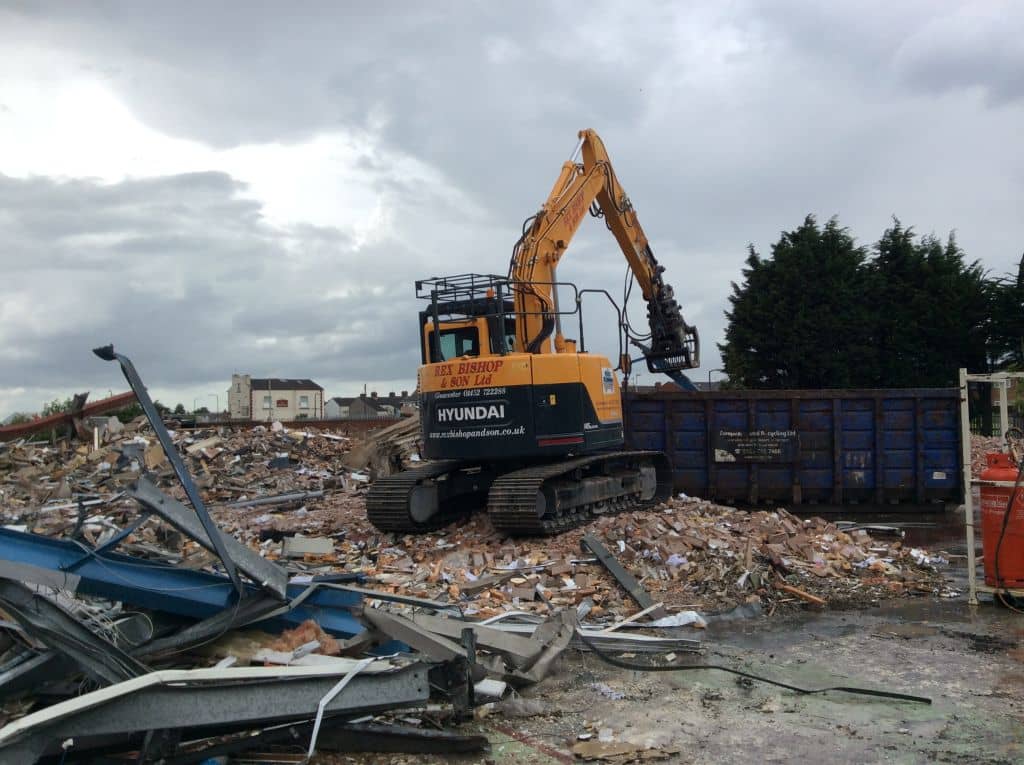 Digger on a pile of rubble