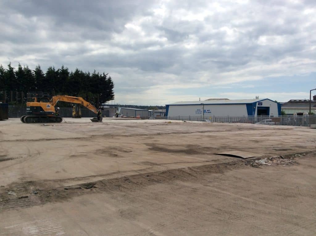 Concrete floor with a digger in the background