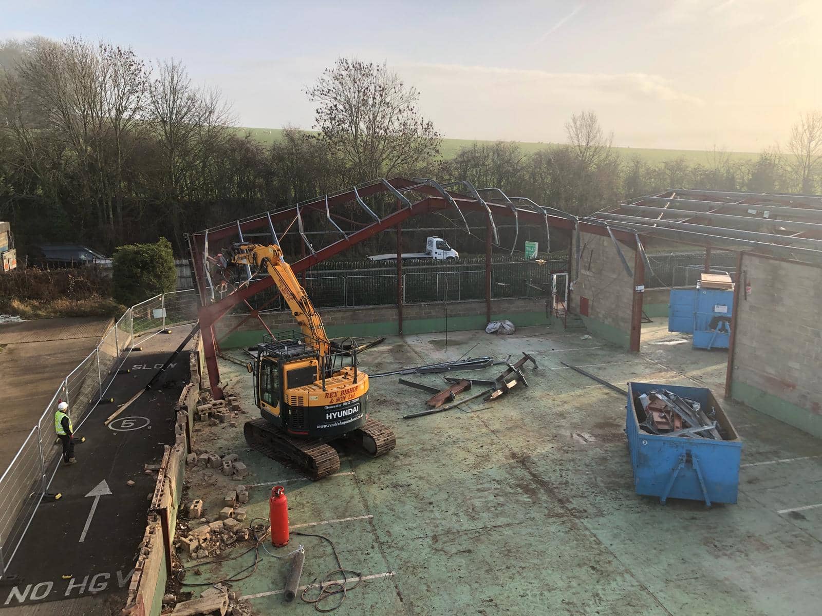 Digger on the outside of an empty building
