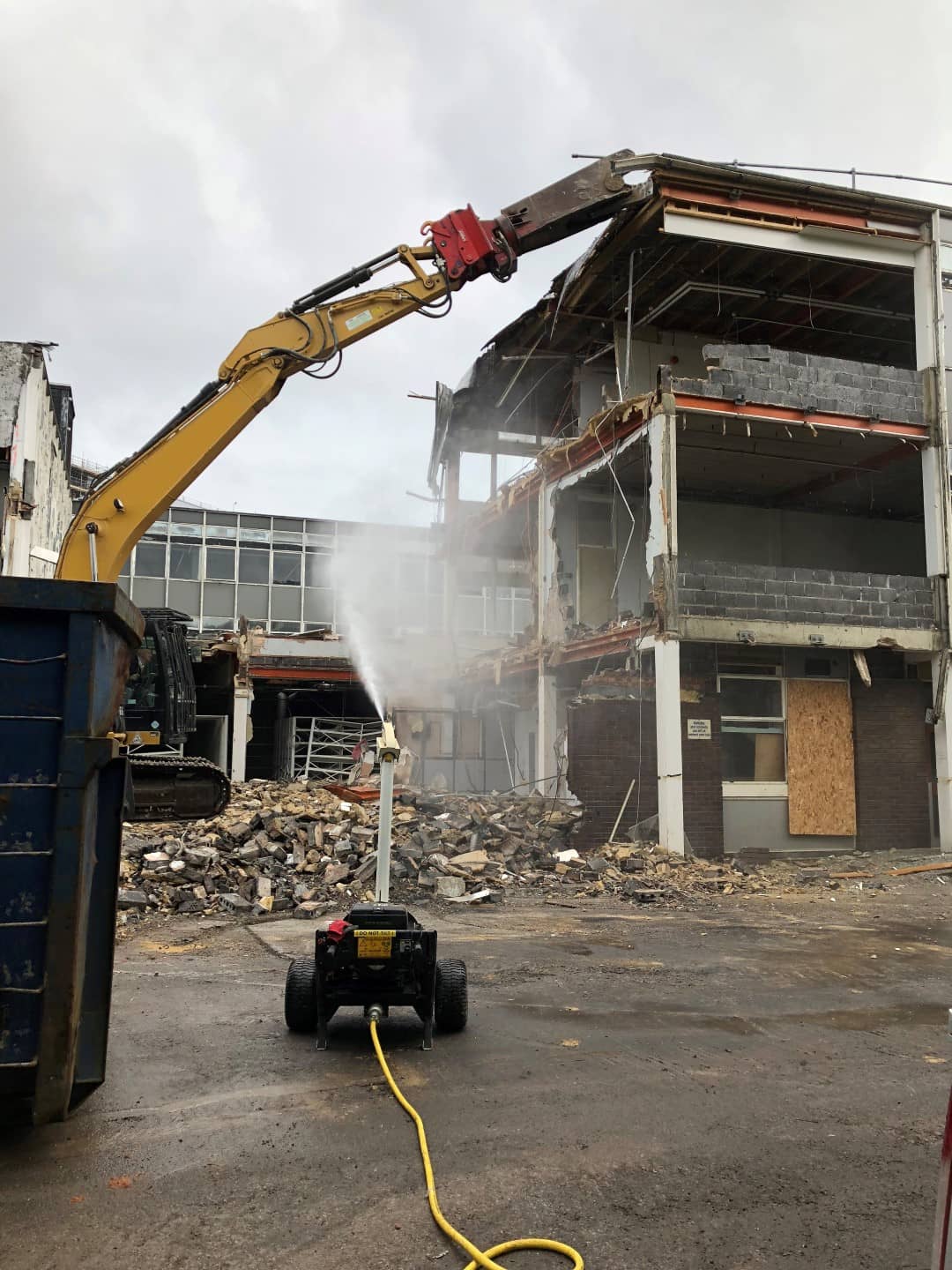 Digger demolishing an empty building