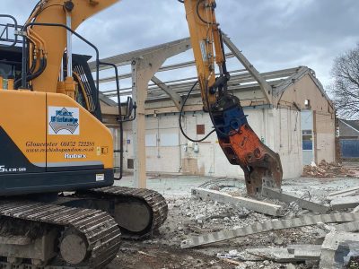 concrete building being reclyled by pulverizer